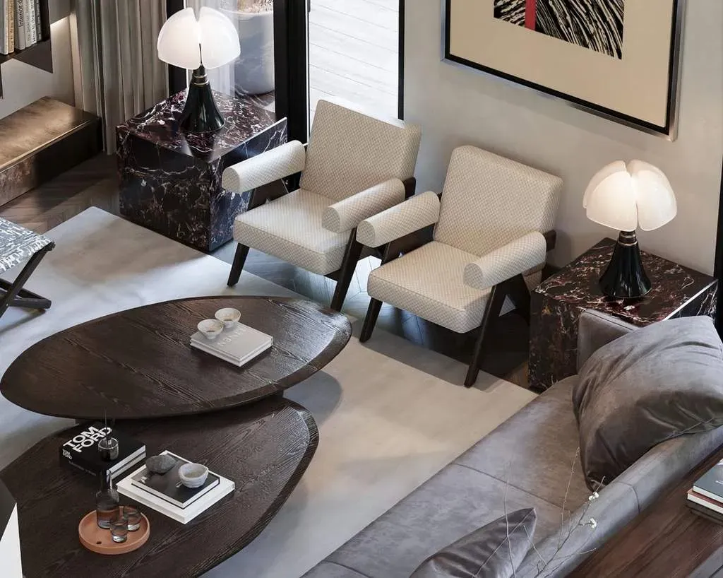 A timber coffee table with books and two reading chairs